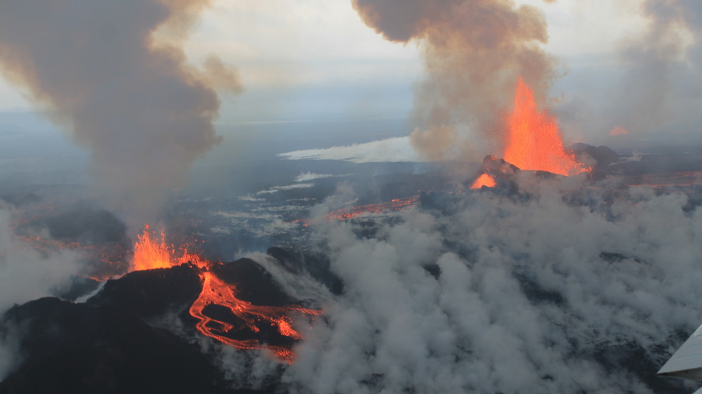 aerial view of two volcanoes erupting