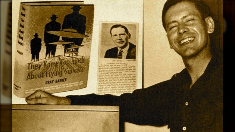 Gray Barker, posing with promotional materials for his book