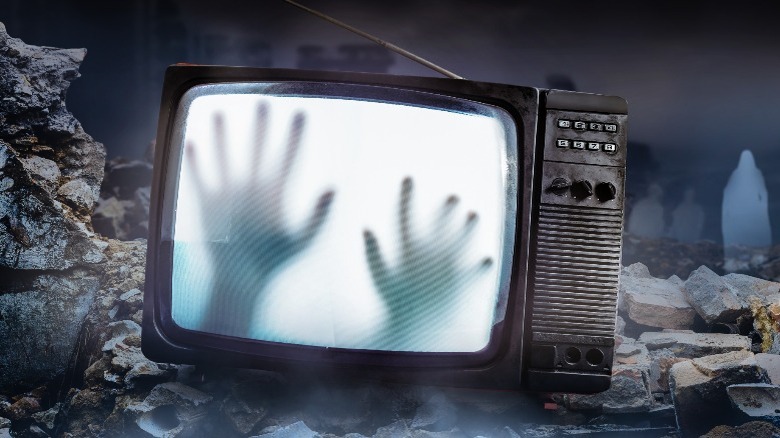 ghostly hands inside a television