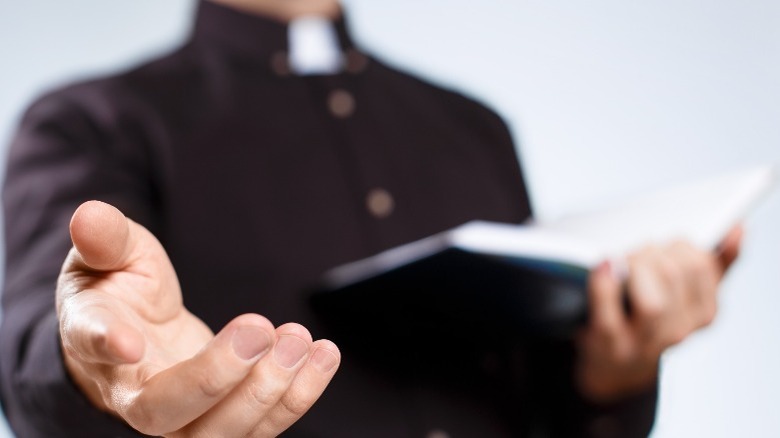 Priest with bible