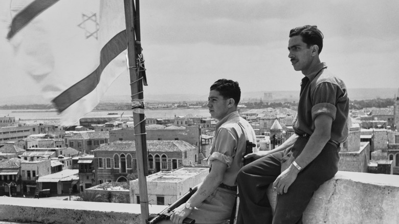 Two Israeli gunmen by Israeli flag