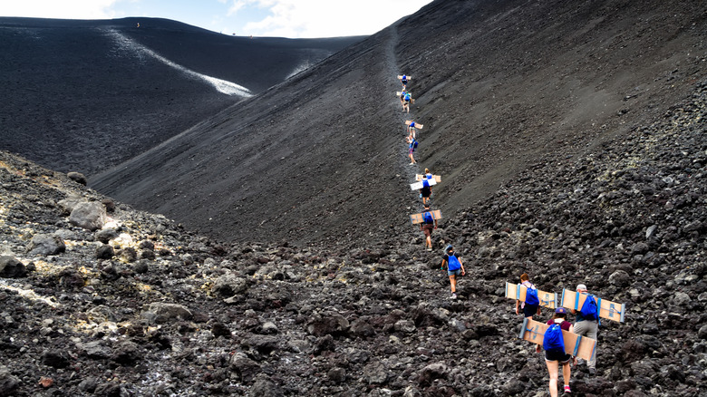 Tourists lined up for volcano boarding