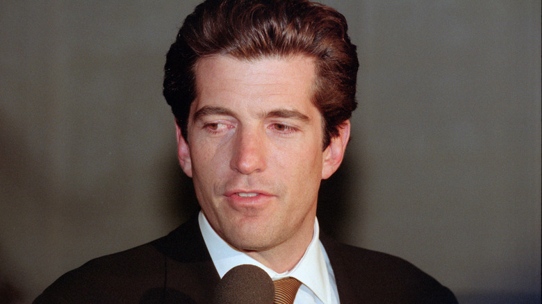 JFK Jr looks down and to the right