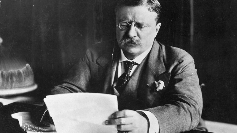 Theodore Roosevelt reads paper