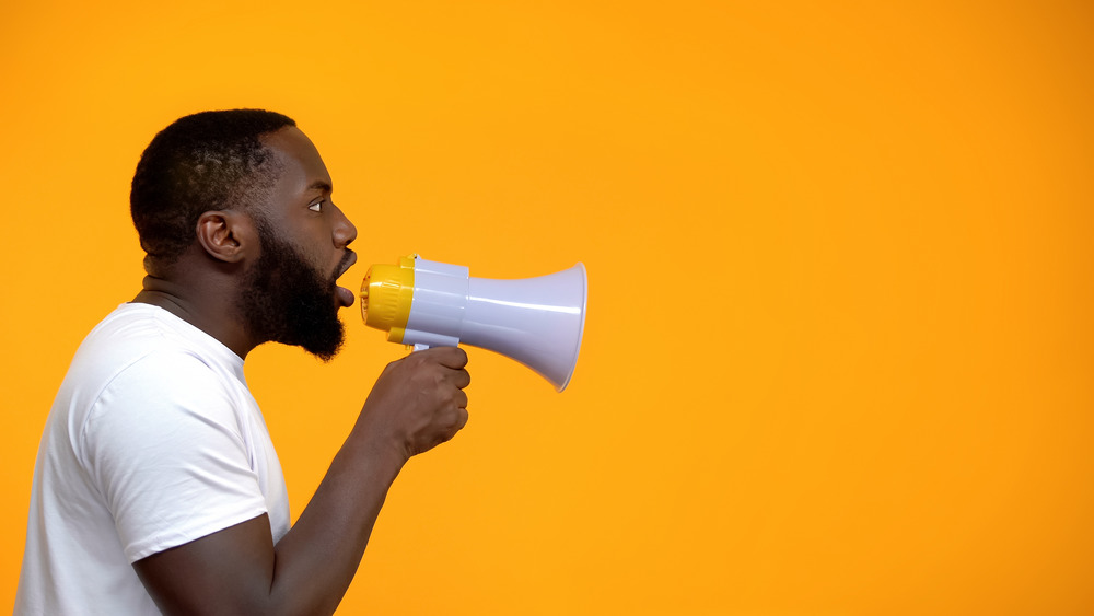 African-American man using megaphone for protest