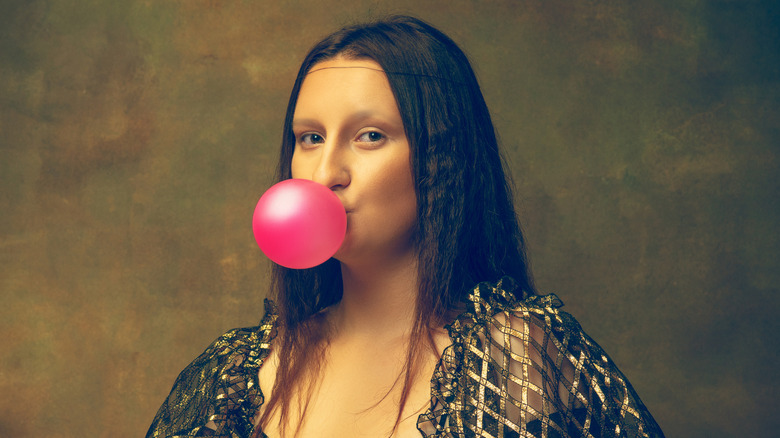 Mona Lisa look alike blowing bubble gum 