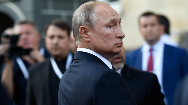 Vladimir Putin looking over shoulder