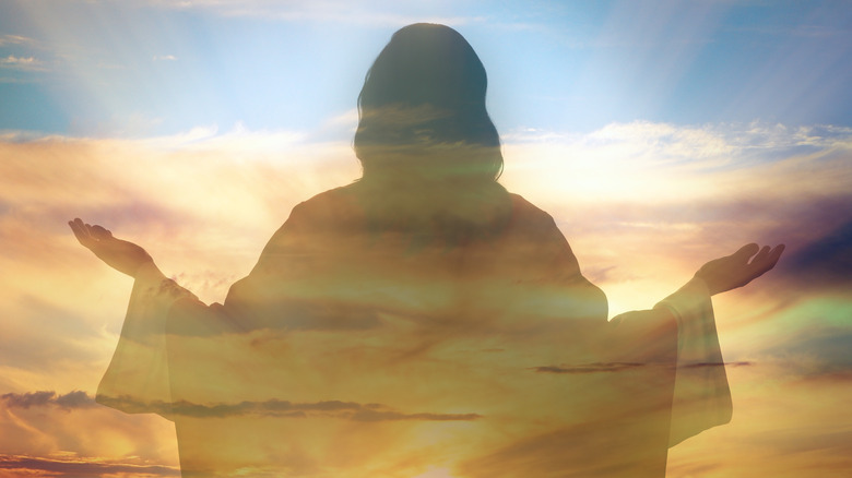 Jesus silhouetted in cloudy sky