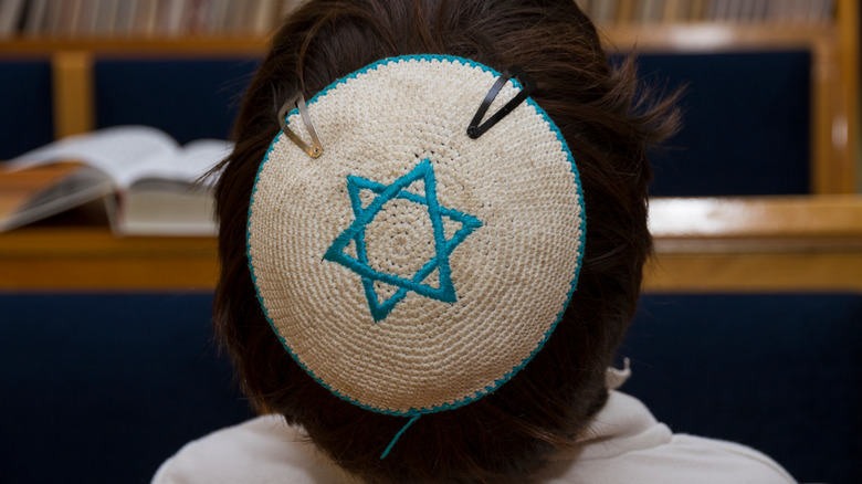 a young person with a yarmulke on their head