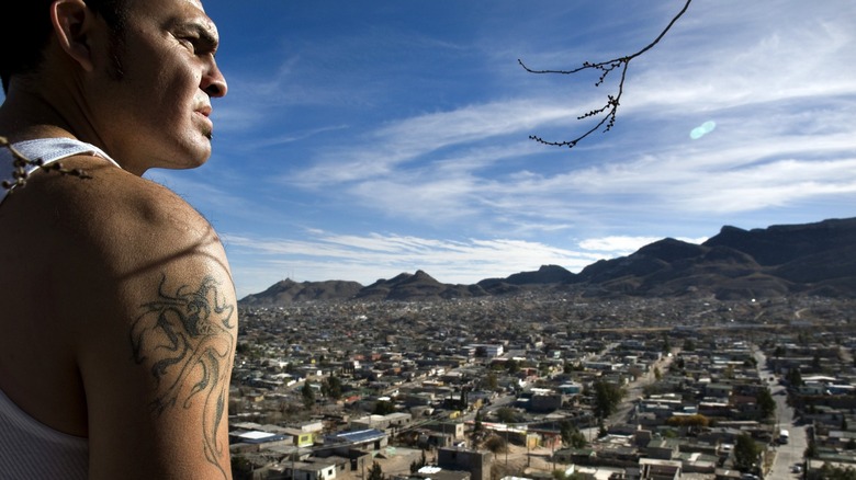 Man tattoos overlooking city