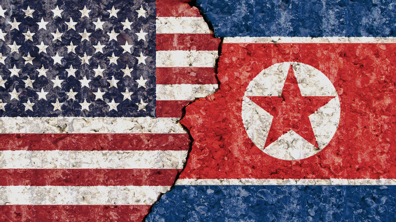 Damaged U.S. and North Korean flags