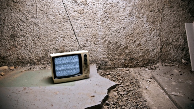 Small TV on broken concrete