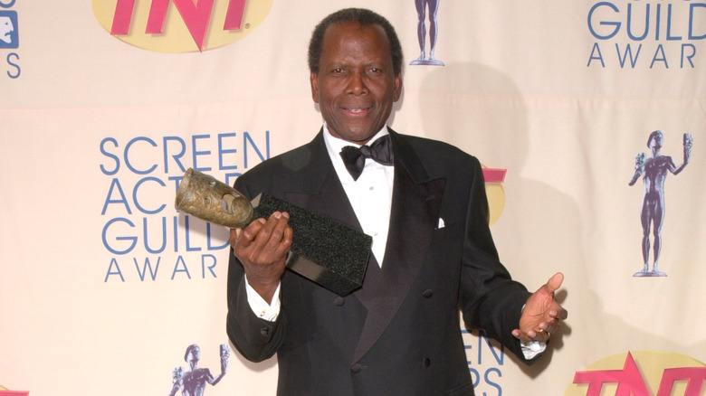 Sidney Poitier holding an award