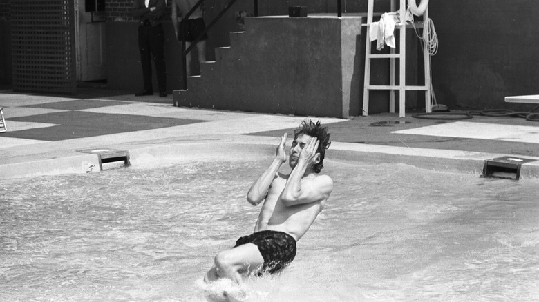 Bob Dylan jumping into a swimming pool in 1964