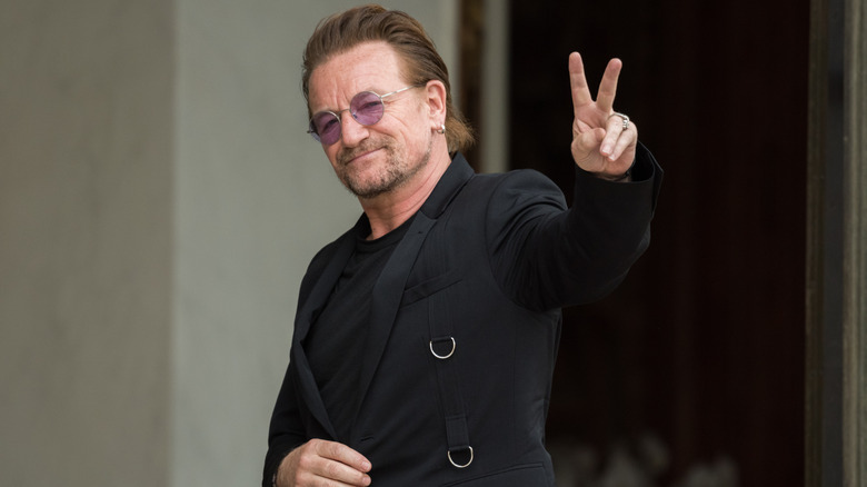 Bono from U2 giving a peace sign to the camera