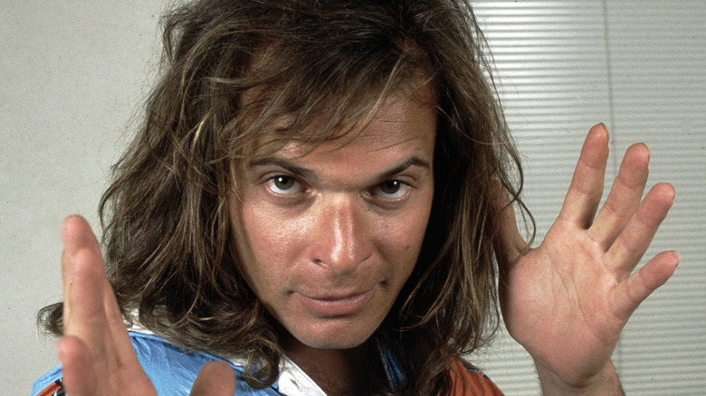 david lee roth holds up hands and makes a silly face