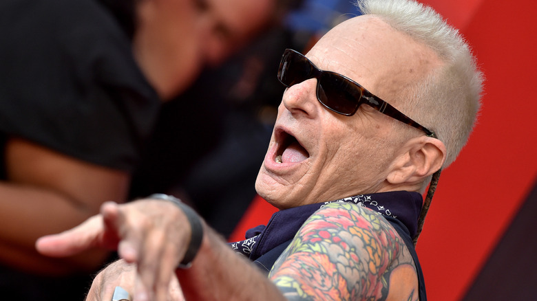 david lee roth squirming with arm and showing off tattoos