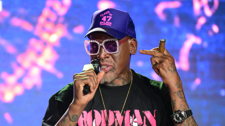 Dennis Rodman hat sunglasses speaking mic at event