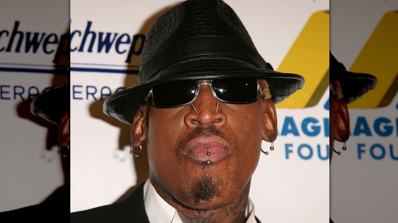 Dennis Rodman sunglasses black hat at event