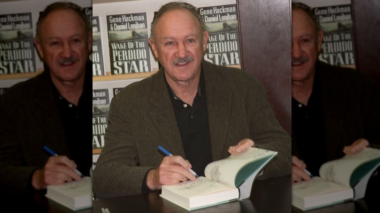 Gene Hackman signing copies of his novel Wake of the Perdido Star