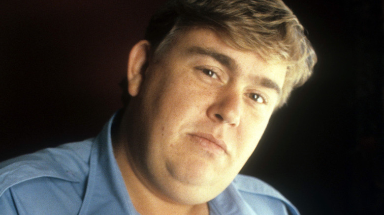 john candy tilting head and looking sensitively into camera