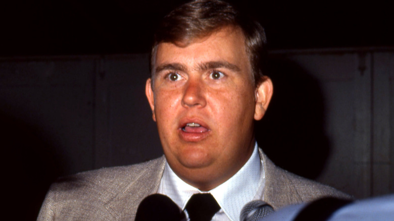 john candy open mouthed in front of microphone