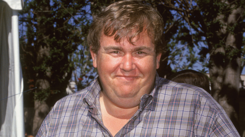 john candy smirking in plaid shirt