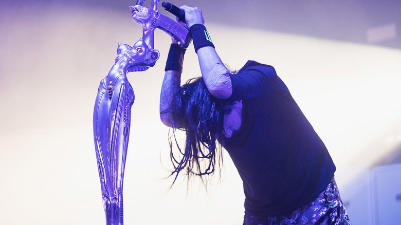 Korn's Jonathan Davis holding onto his mic stand at the Pain in the Grass Festival 2017