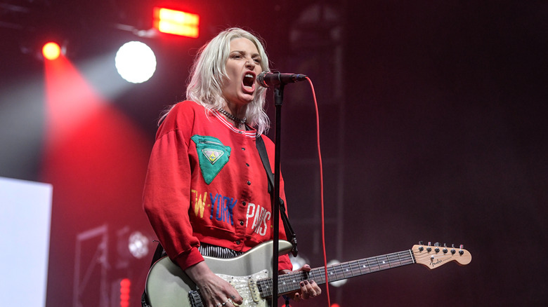 emily armstrong red shirt playing guitar