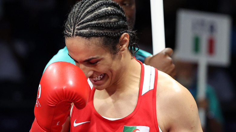 Imane Khelif smiling red jersey boxing glove