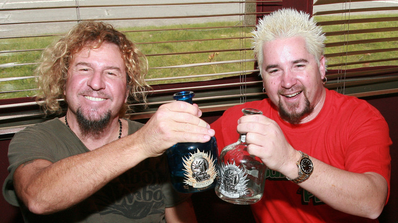 sammy hagar toasting tequila bottles with guy fieri