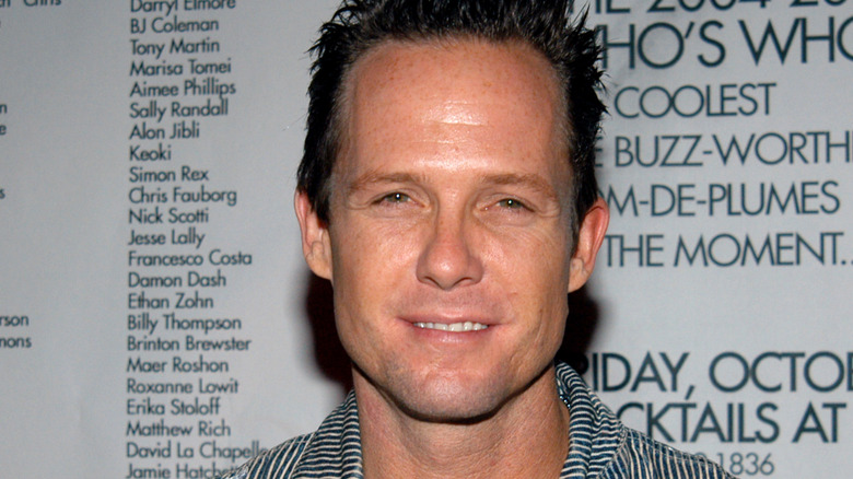 dean winters smiling squinting striped shirt