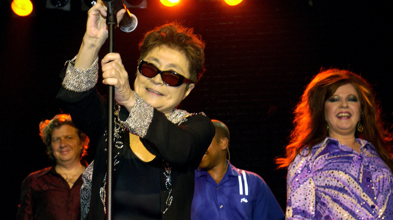 yoko ono smiling onstage with kate pierson of the b-52's