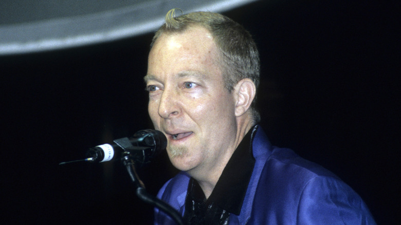 fred schneider of the b-52's smirking onstage