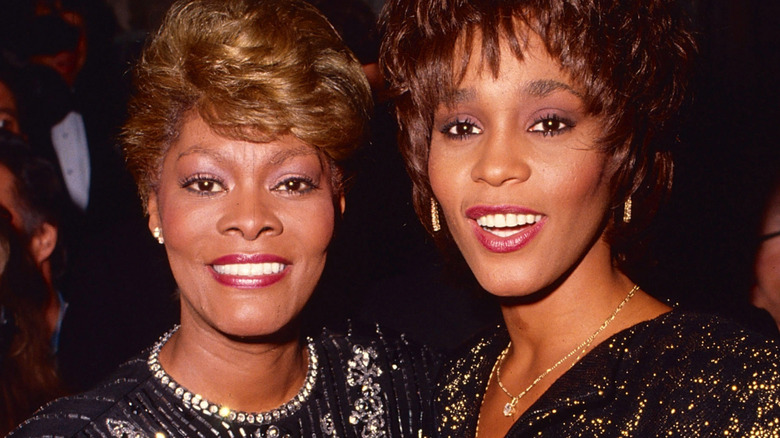 whitney houston and dionne warwick smiling into camera