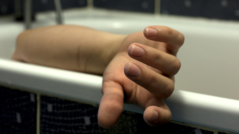 Hand of woman dead in bathtub