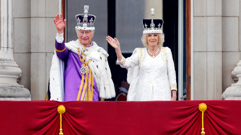 King Charles and Queen Camilla waving