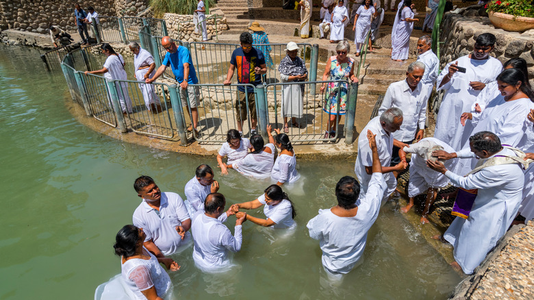 people gathered for baptism in yardenit