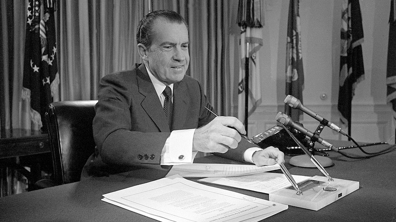 Richard Nixon signing papers