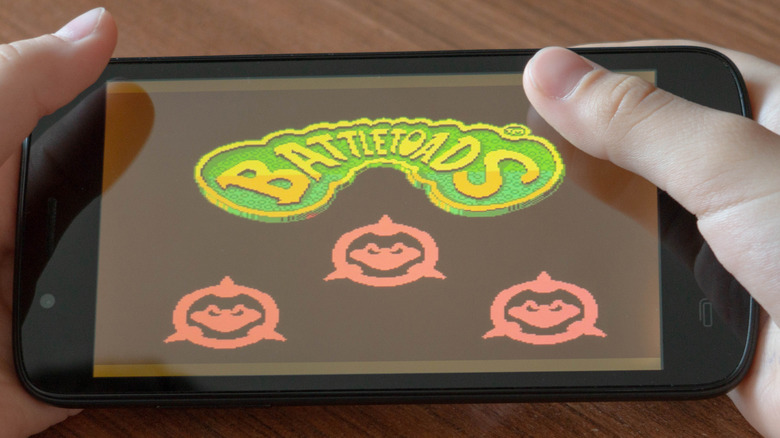 child playing battletoads on phone