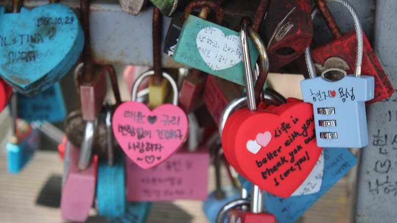 Love padlocks latched to bridge