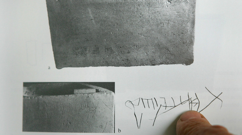 Researcher pointing to ossuary inscription