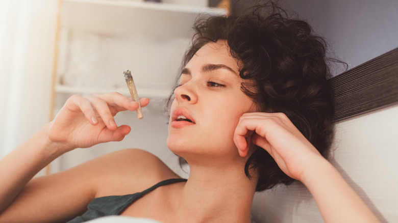 a woman smoking a joint