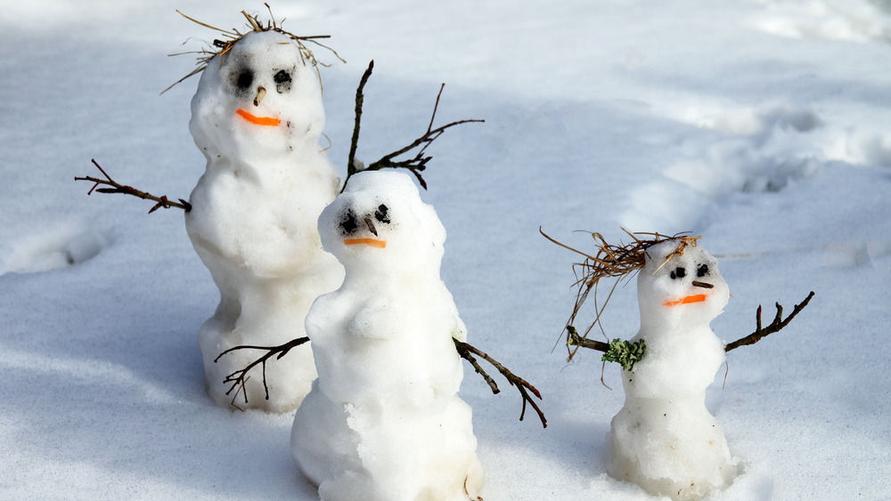 A family of somewhat ramshackle, melted snowmen