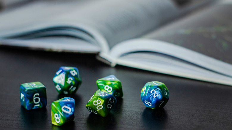 dice with a book in the background