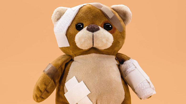 Bandaged and bruised teddy bear