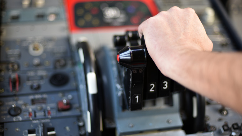 Hand on cockpit instrumental panel