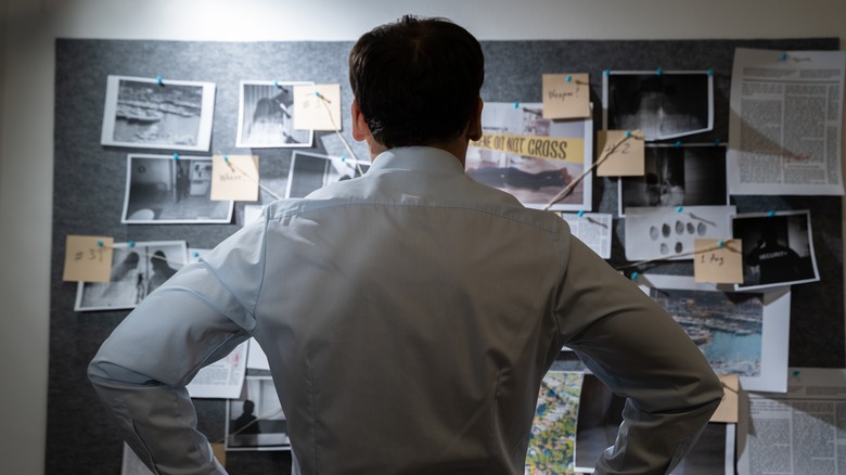 A police detective examining an investigation board