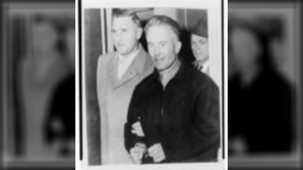 ed gein walking with handcuffs