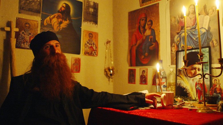 bearded Romanian Catholic sitting 